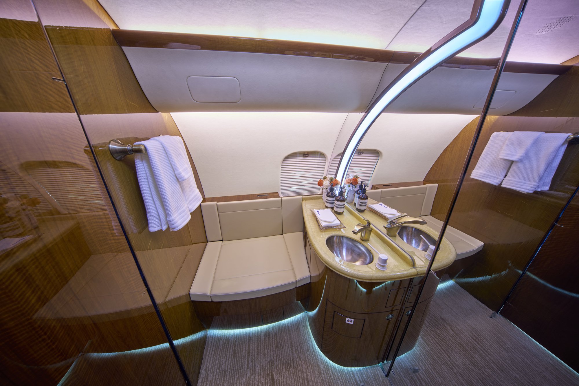 2007 Bombardier Global 5000 aft lavatory with dual sinks and wood cabinetry