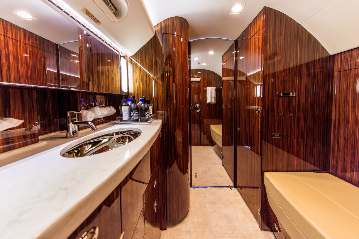 Aft lavatory featuring sink and vacuum toilets with outside servicing capability on the Gulfstream G550.