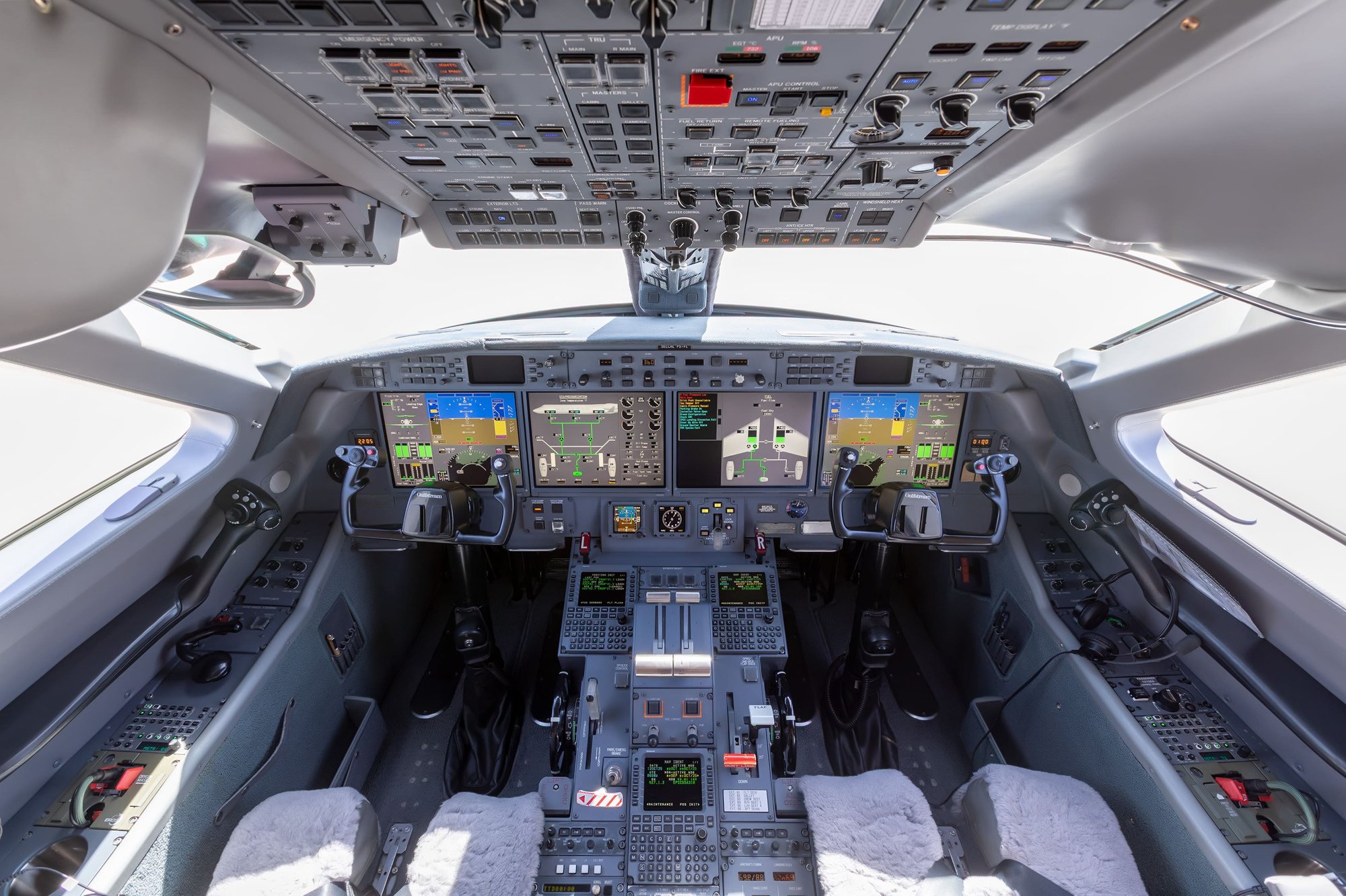 The cockpit of this 2010 Gulfstream G550 features the advanced PlaneView avionics suite, offering pilots exceptional situational awareness and control. Equipped with four large LCD displays, dual control yokes, and a comprehensive overhead panel, the flight deck combines cutting-edge technology with ergonomic design for optimal safety, performance, and ease of operation on long-range missions.
