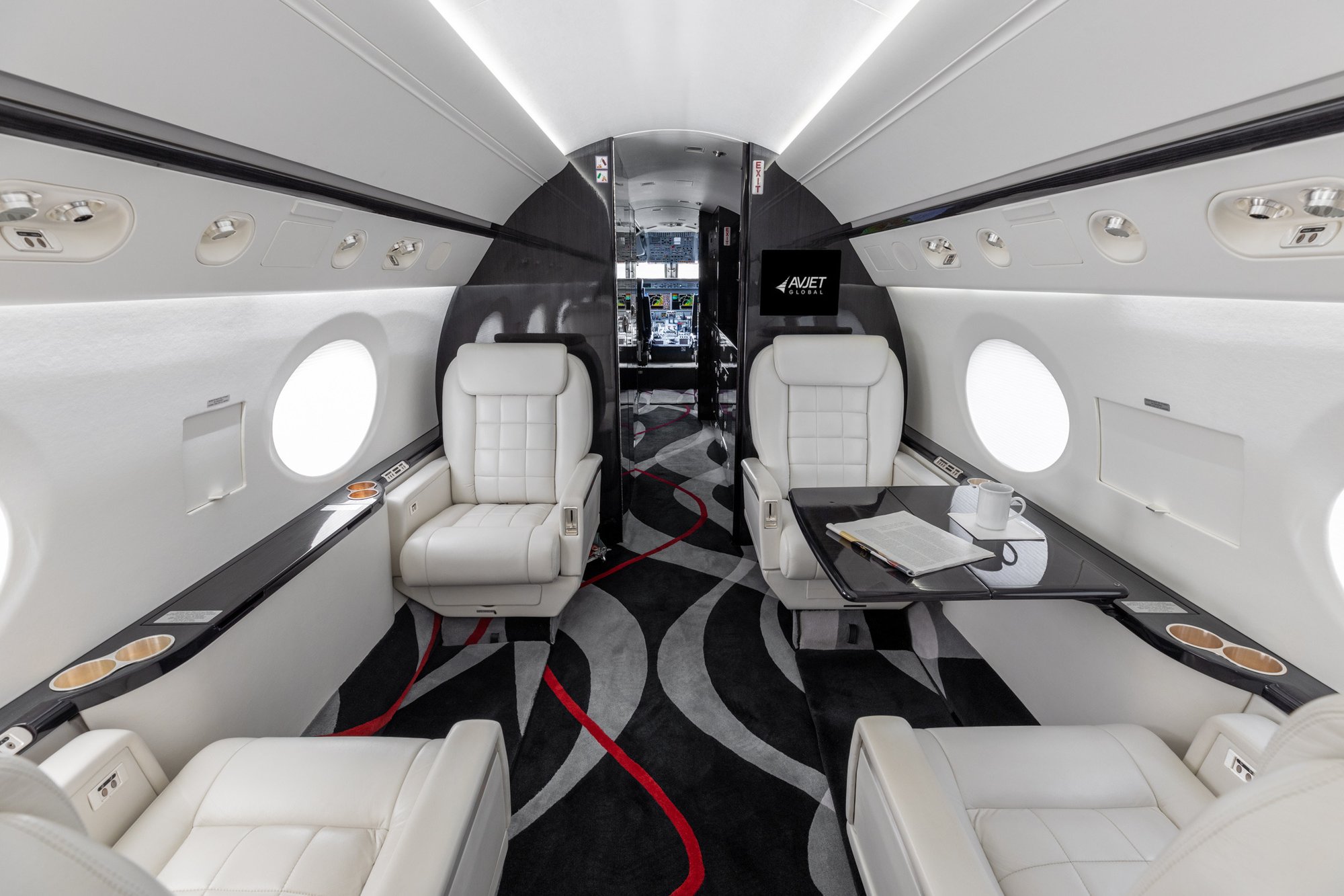 Interior view of the first four passenger seats in the 2005 Gulfstream G550, showcasing luxurious leather upholstery and spacious seating arrangements.