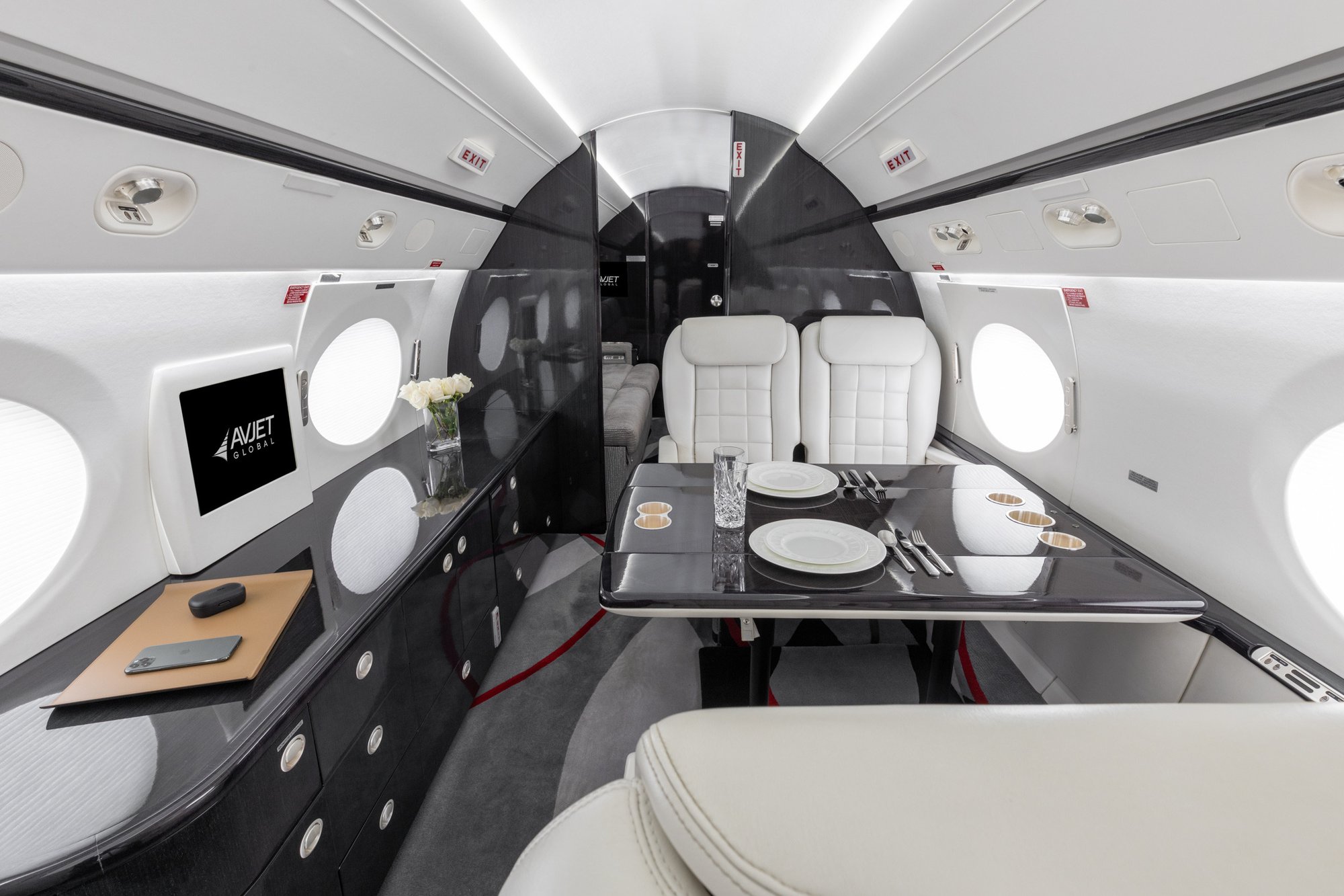 Interior view of the mid cabin in the 2005 Gulfstream G550, featuring a left four-place conference group with plush seating and a stylish credenza.