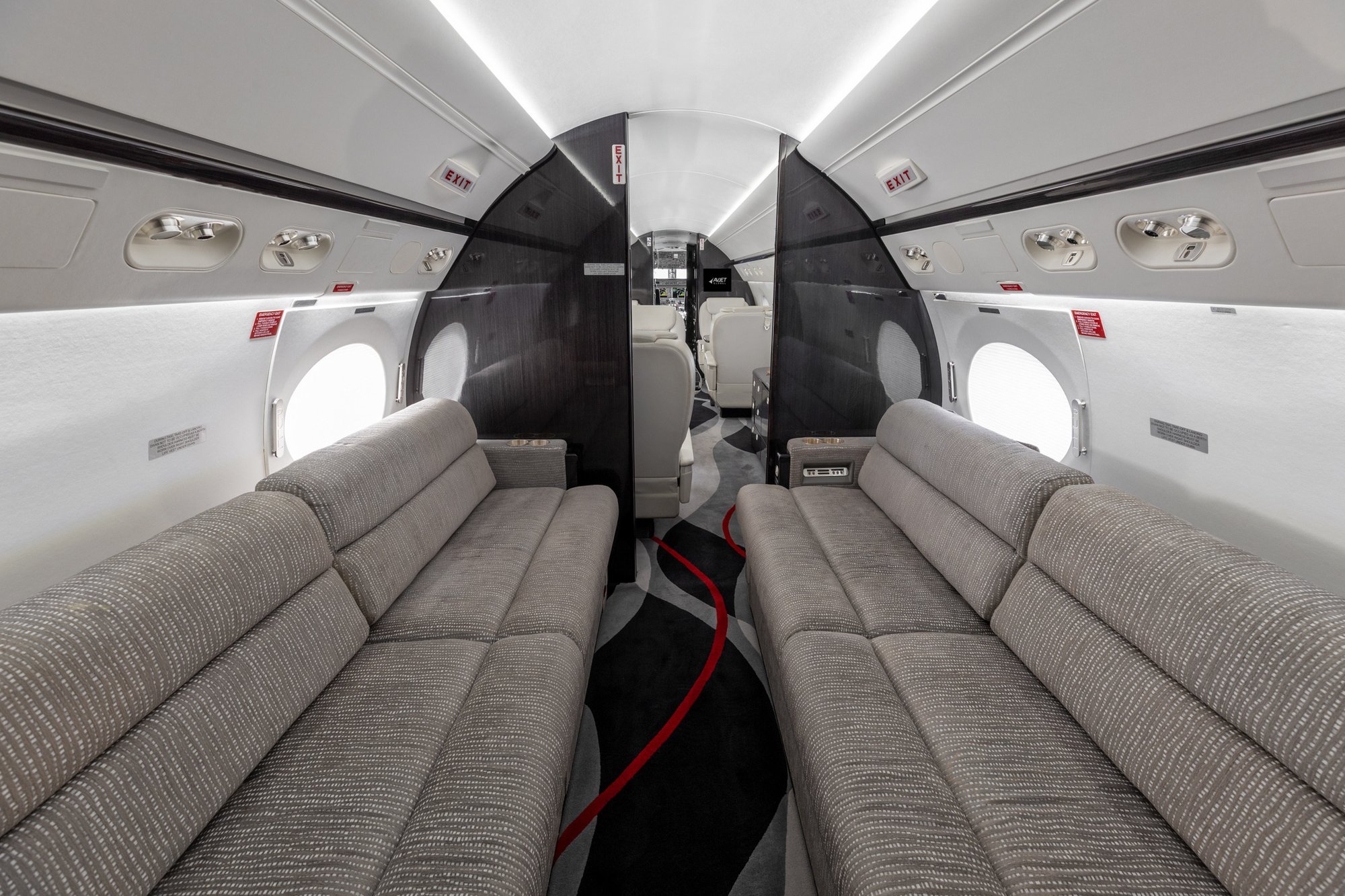 Aft cabin of the 2005 Gulfstream G550 showcasing dual berthing four-place divans for luxurious seating and comfort.