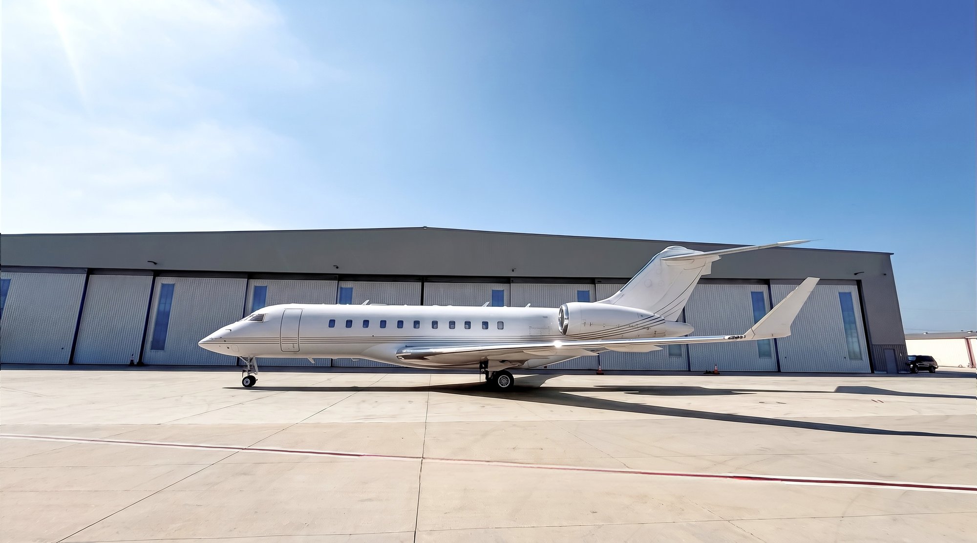 2007 Bombardier Global 5000 private jet parked on the ramp, exterior side view