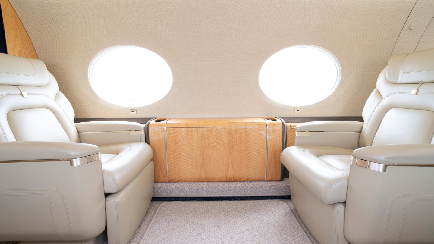 Elegant forward cabin with a four-place club seating arrangement and two-fold-out side ledge tables for meetings or leisure.