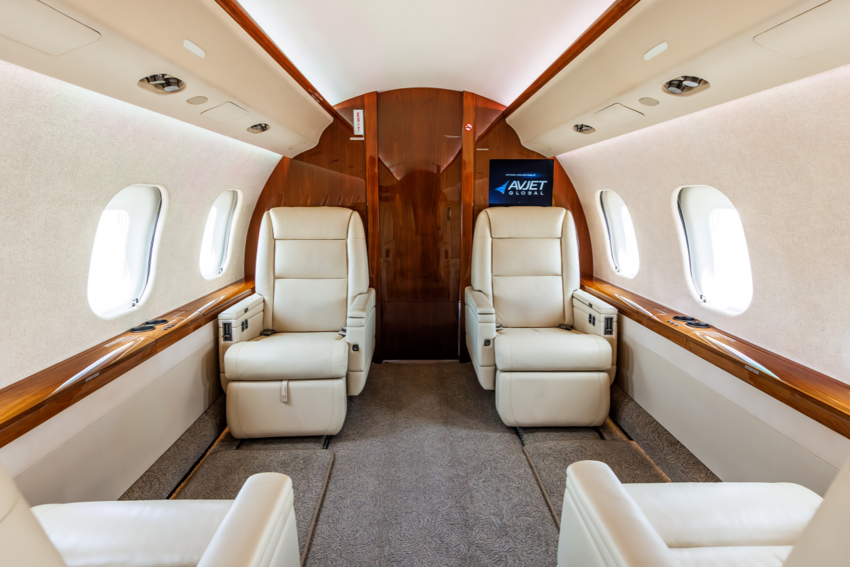 Front-facing view of the forward cabin in a 2006 Bombardier Global XRS jet, showcasing four seats.