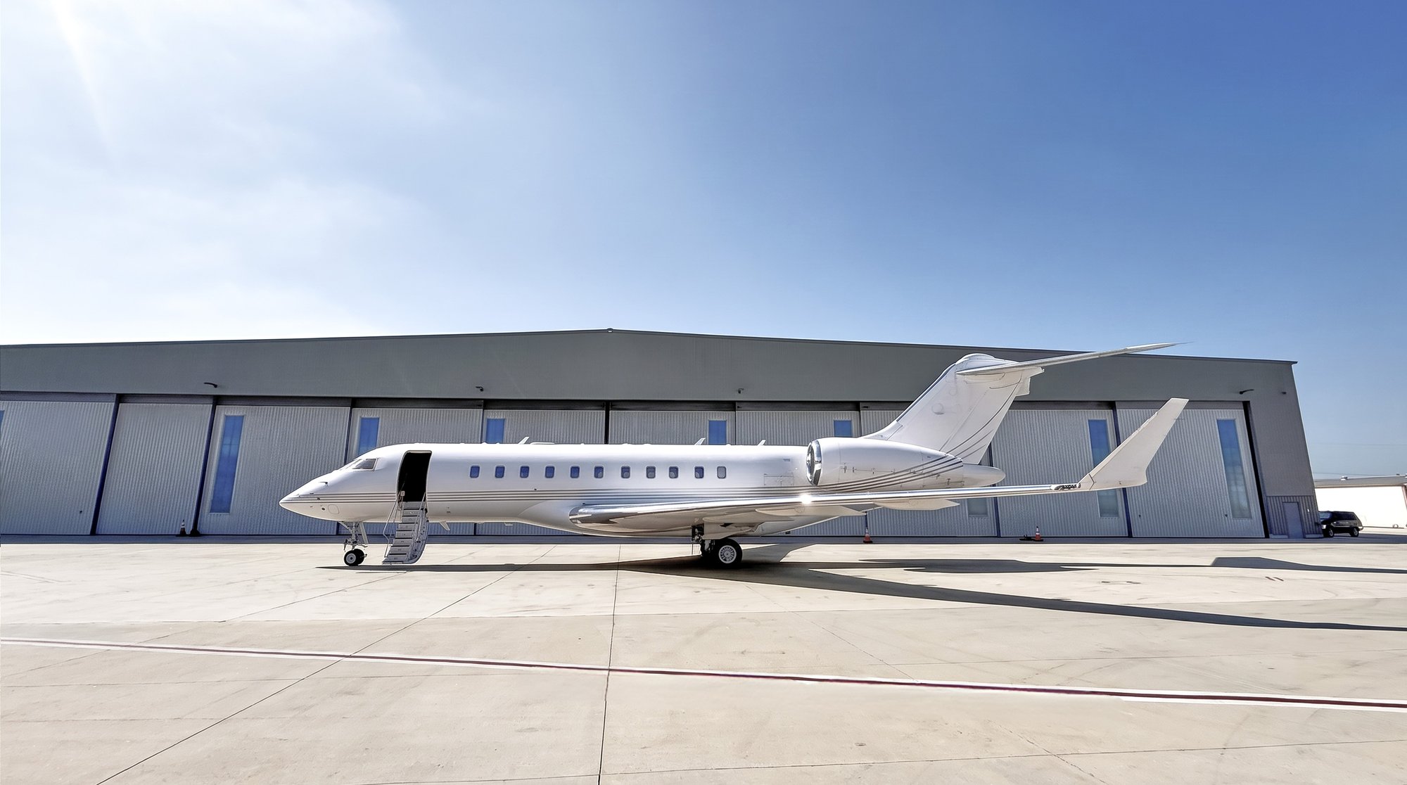 2007 Bombardier Global 5000 private jet parked on the ramp, exterior side view