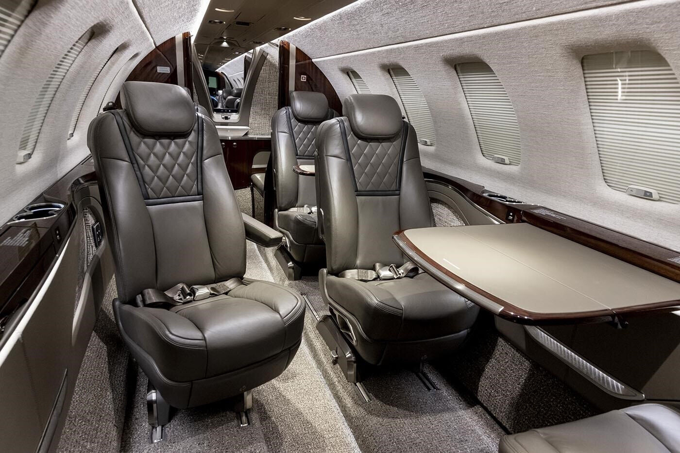 Interior view showing six cabin seats and a forward side-facing two-place seat in the 2023 Citation CJ4 Gen2 private jet.