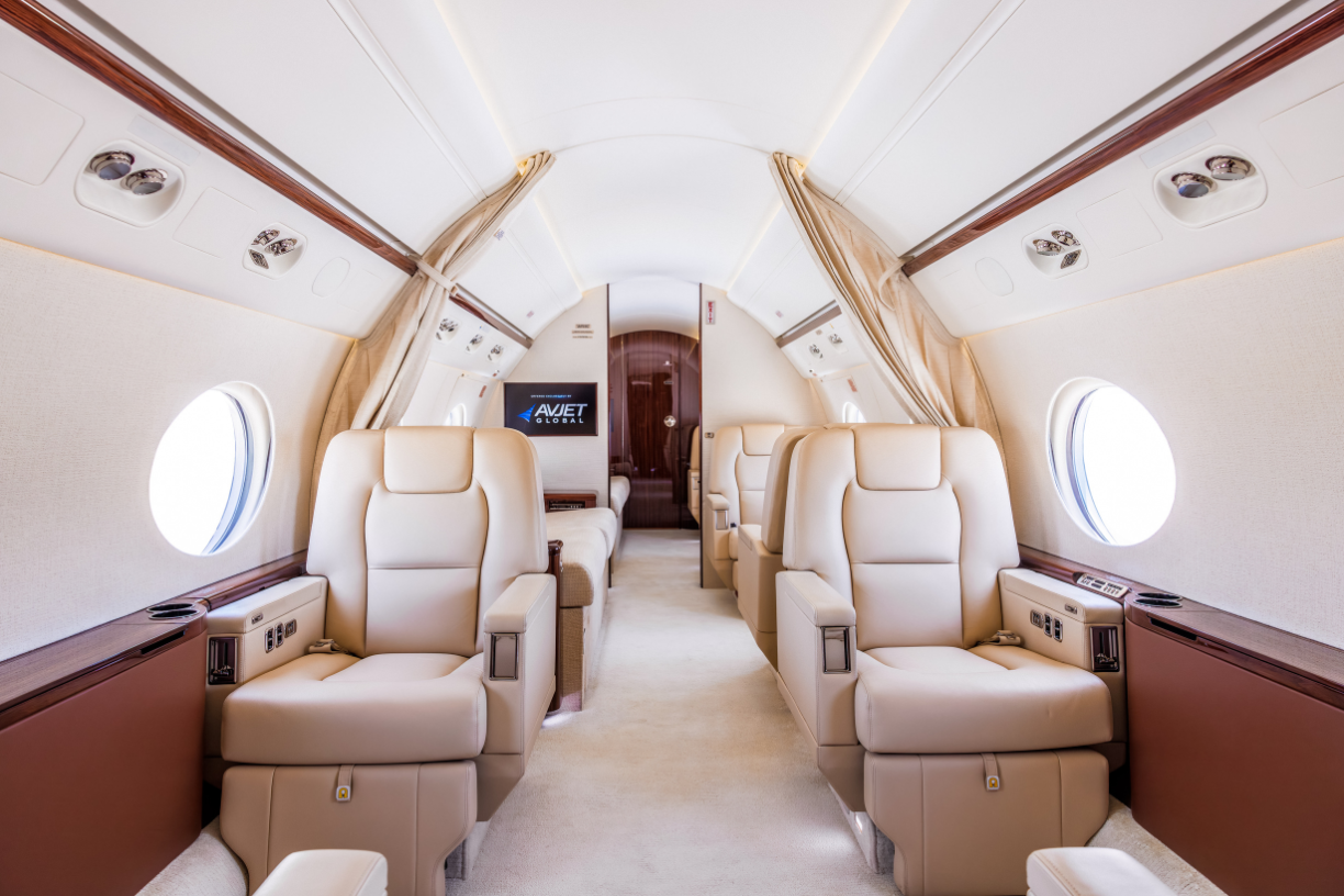 Interior view of the first four seats in the 2016 Gulfstream G550, featuring luxurious leather seating, spacious cabin, and modern amenities.