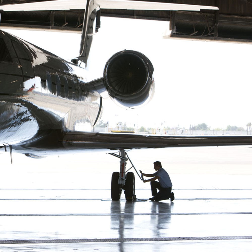 Technician-inspecting-aircraft