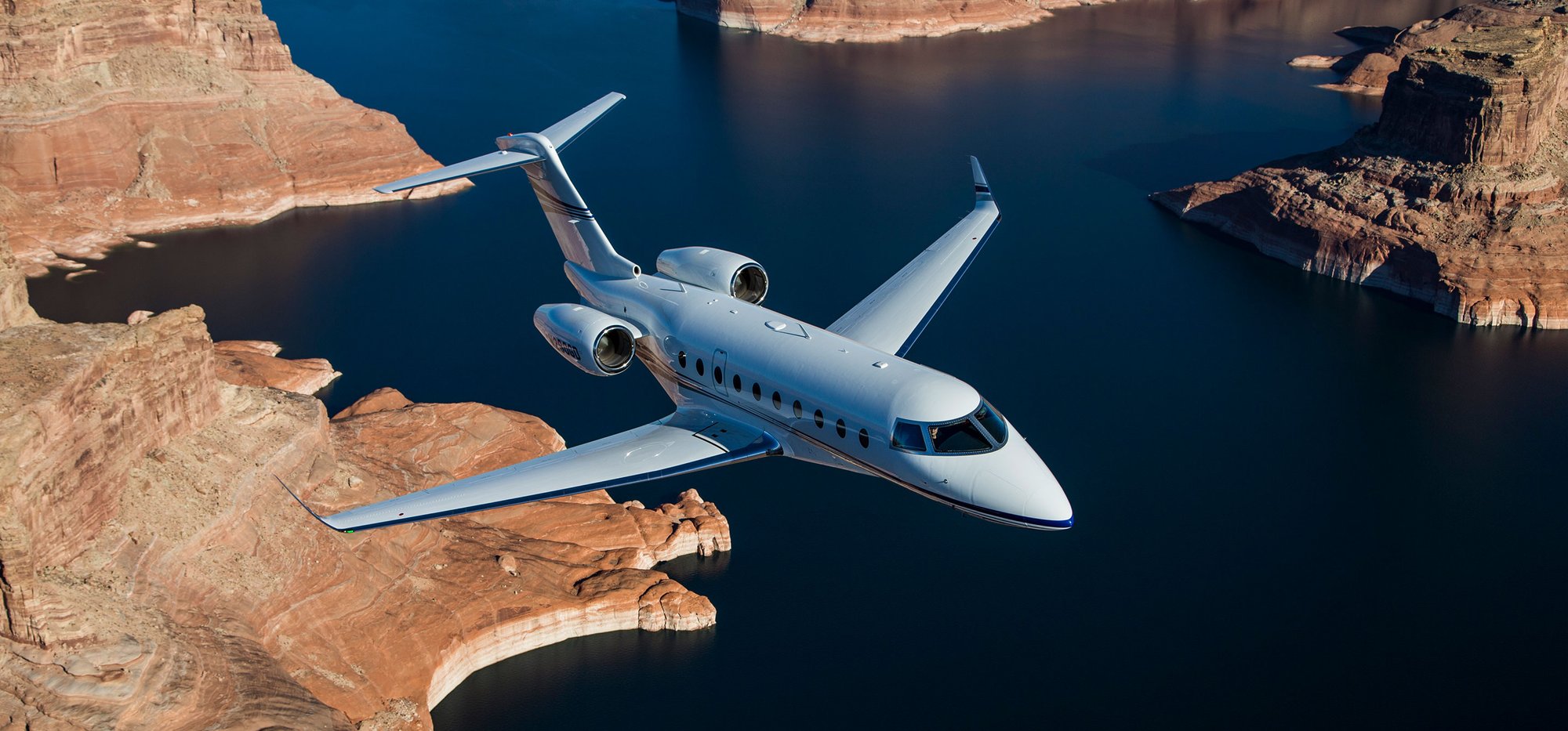 Gulfstream flying over sea and red canyons