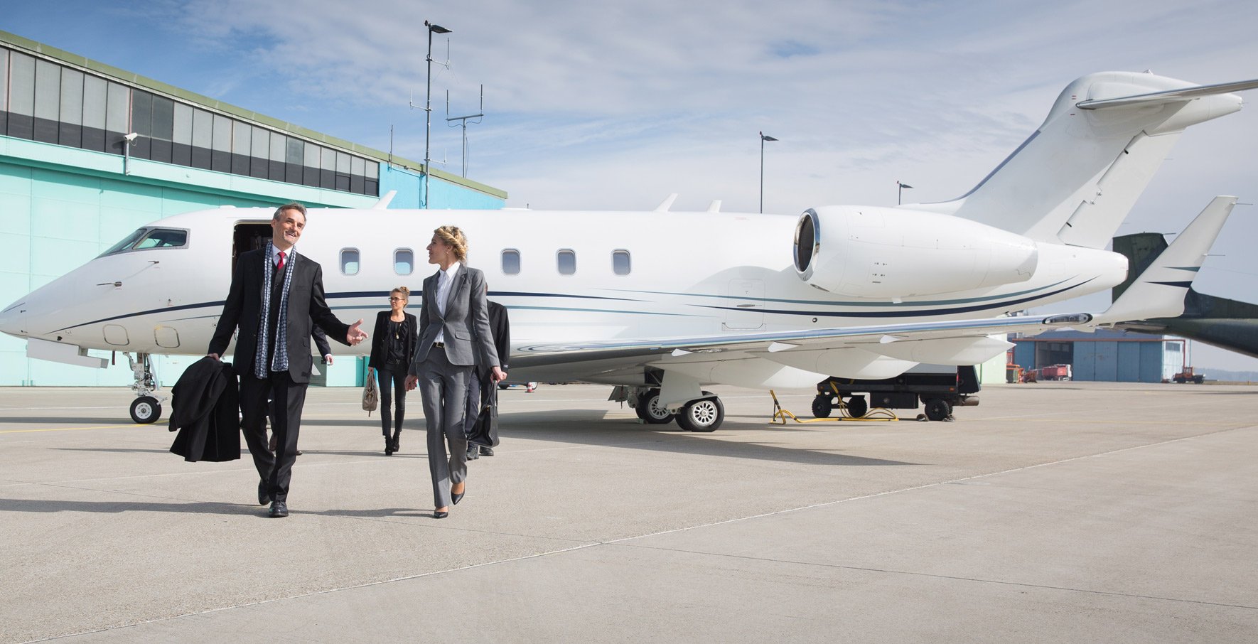 Businesspeople departing private jet