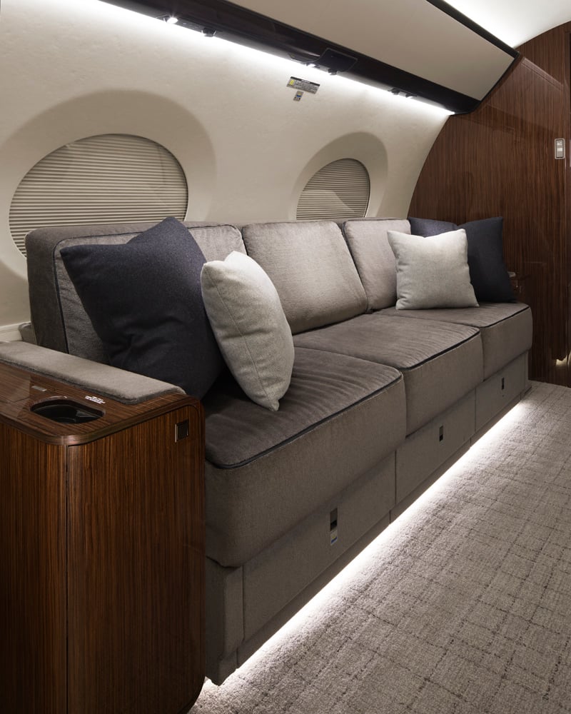 Divan offers a spacious and comfortable seating area with refined finishes, providing an inviting space for passengers to relax, unwind, or rest during long-range flights.