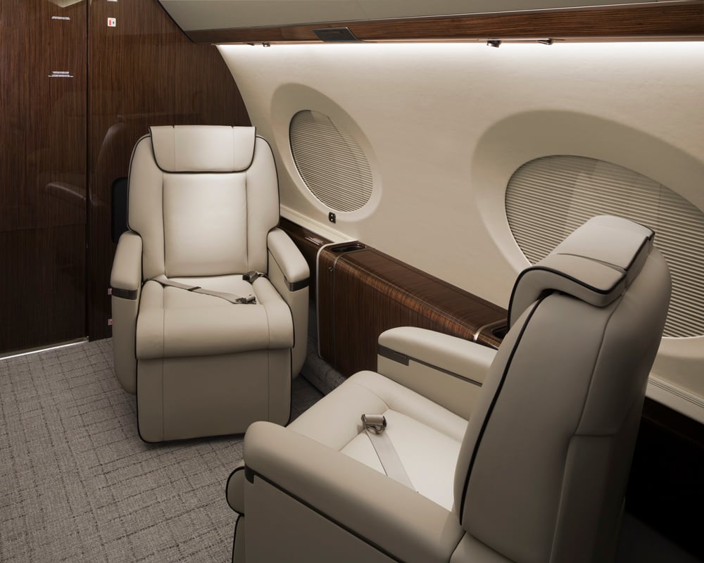 Forward Cabin features individual single seats designed for privacy and comfort, with a spacious layout, refined finishes, and an elegant environment ideal for relaxing or working during long-range flights.