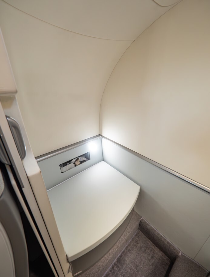 2022 HondaJet Elite S private jet lavatory featuring an enclosed toilet area with clean modern finishes, compact layout, and efficient space design for business aviation.