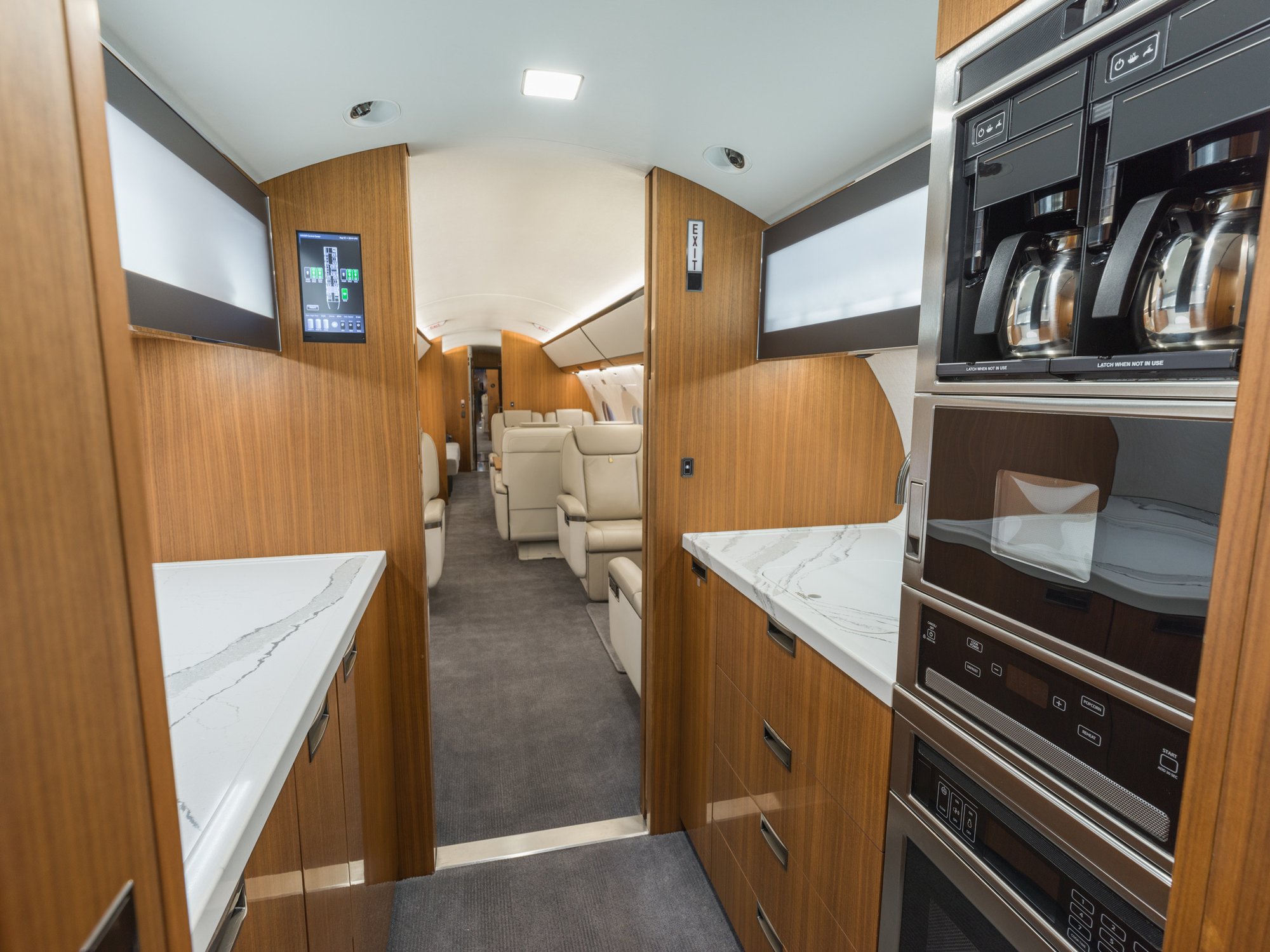 Forward galley of the Gulfstream 650ER, featuring high-end appliances, sleek cabinetry, and ample counter space, designed for top-tier in-flight dining and convenience.