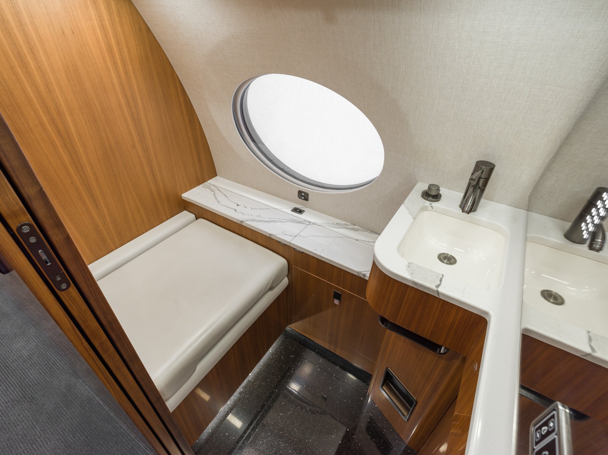 Forward lavatory of the Gulfstream 650ER, featuring elegant fixtures and modern design, providing a sophisticated and functional space for passengers.