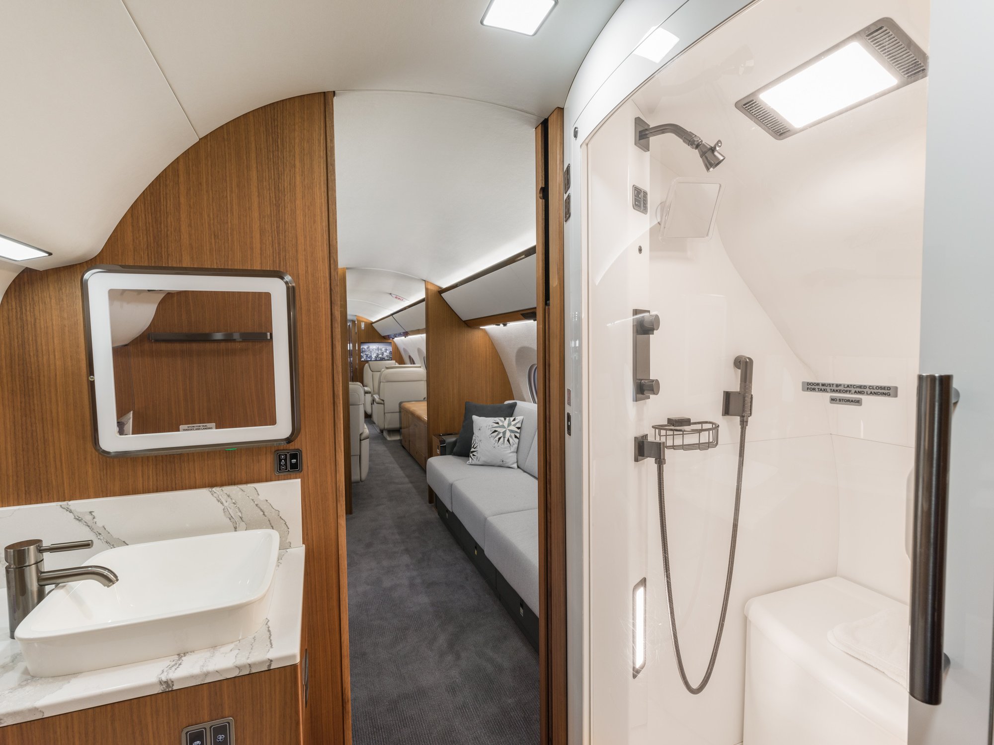 Luxurious aft lavatory of the Gulfstream 650ER, featuring elegant fixtures and premium finishes for a refined in-flight experience.