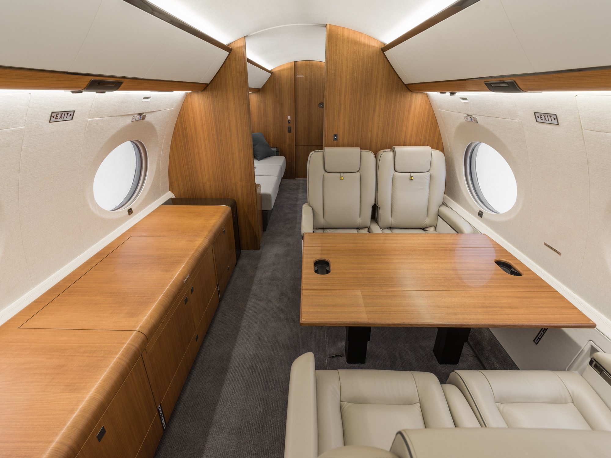 Elegant mid-cabin of the Gulfstream 650ER featuring four luxurious leather seats, designed for optimal comfort and seamless travel experience