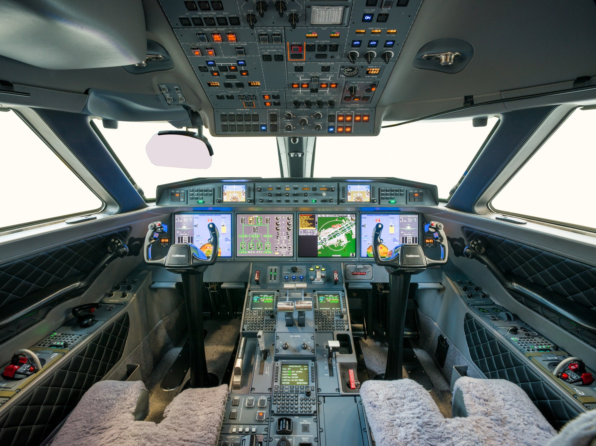 Flight deck of the Gulfstream 650ER, showcasing advanced avionics, sleek control panels, and a high-tech cockpit designed for optimal pilot performance and safety.