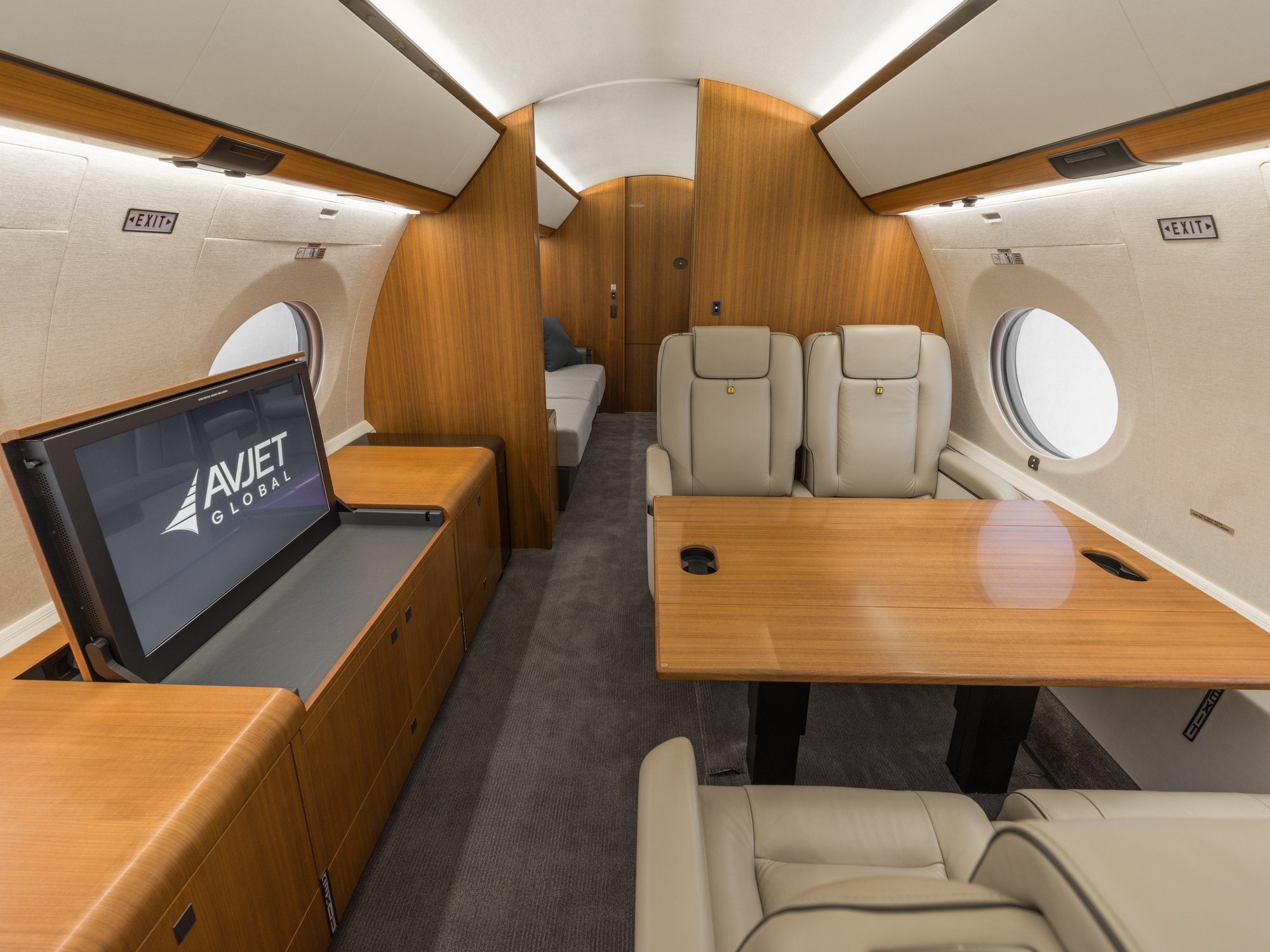 Mid-cabin view of the Gulfstream 650ER looking aft, showcasing a seamless transition to the spacious aft cabin with luxurious seating and refined finishes.