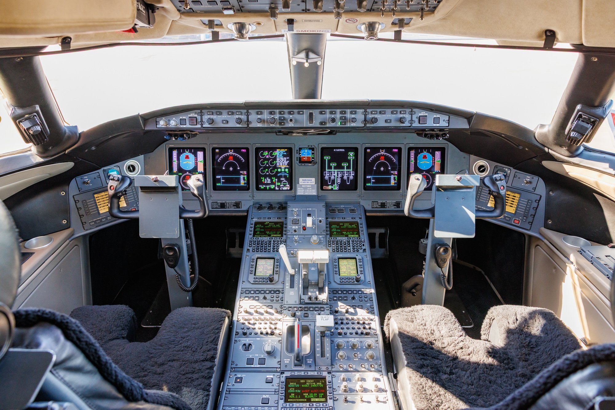 Flight deck of a Bombardier Global private jet showcasing advanced avionics suite, dual yokes, multi-display instrumentation, and ergonomic design engineered for precision and performance.