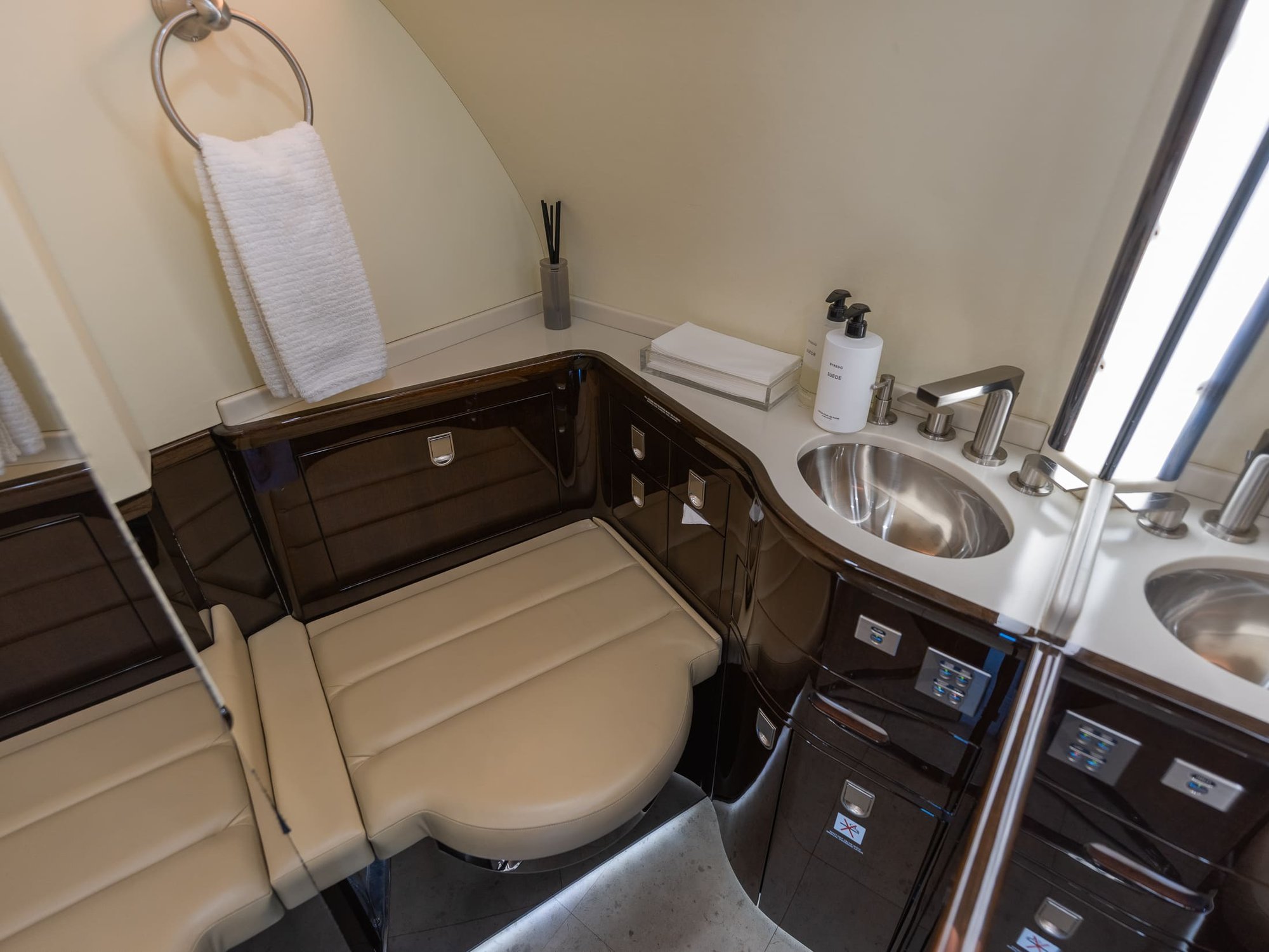 The VIP Lavatory aboard the 2007 Bombardier Global XRS features elegant wood cabinetry, premium fixtures, a spacious vanity, and refined leather seating. Designed for comfort and privacy, this sophisticated lavatory complements the aircraft’s luxurious interior.
