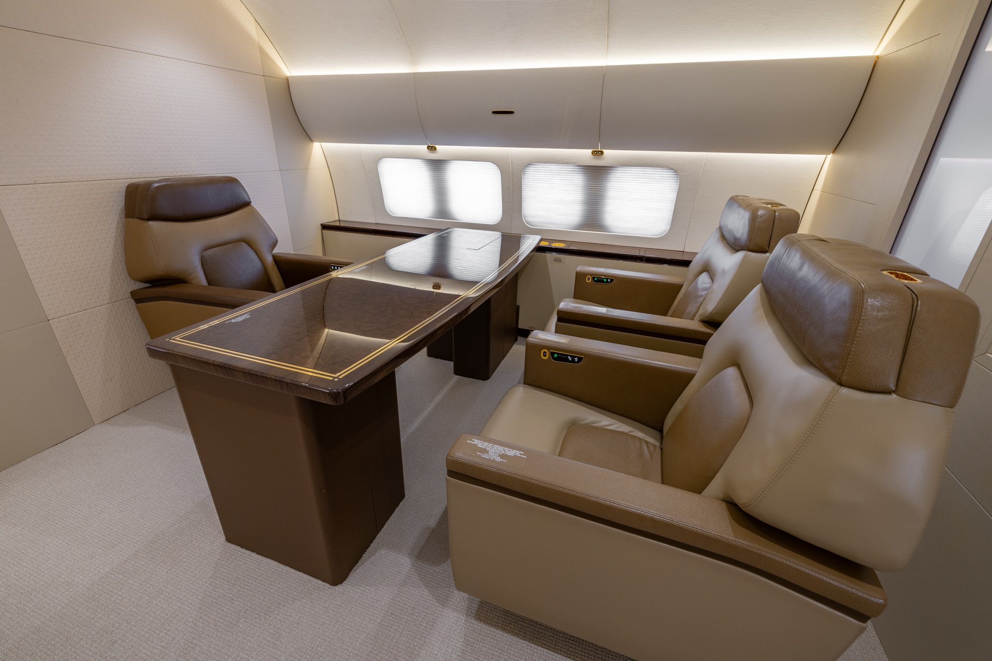 The VIP Office – Forward View aboard the 2018 Boeing Business Jet 2 (BBJ2) provides a private and productive workspace featuring executive leather seating, a premium conference table, and elegant wood finishes. Designed for business travelers, this sophisticated office delivers comfort, privacy, and functionality for meetings or work while in flight.