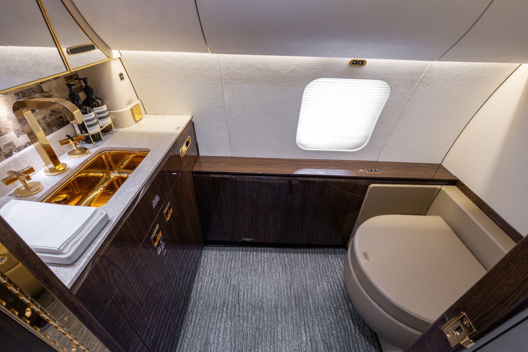 Elegant guest lavatory featuring premium finishes, refined fixtures, and a space-efficient design that provides comfort and convenience aboard the Boeing Business Jet 2 (BBJ2).