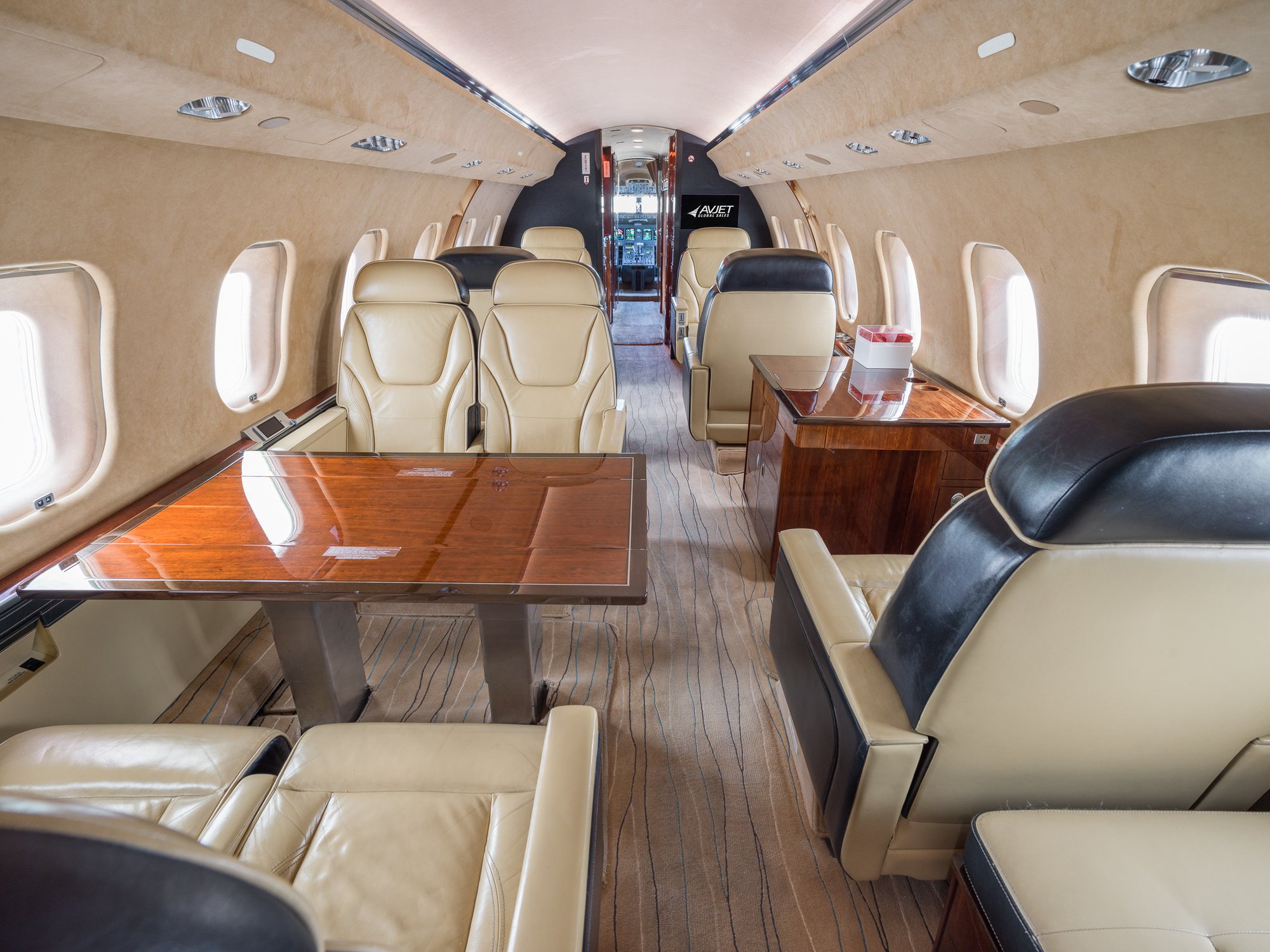 Mid cabin view of the 2007 Bombardier Global XRS looking forward, showcasing the elegant seating and refined interior layout that enhances comfort during private flights.