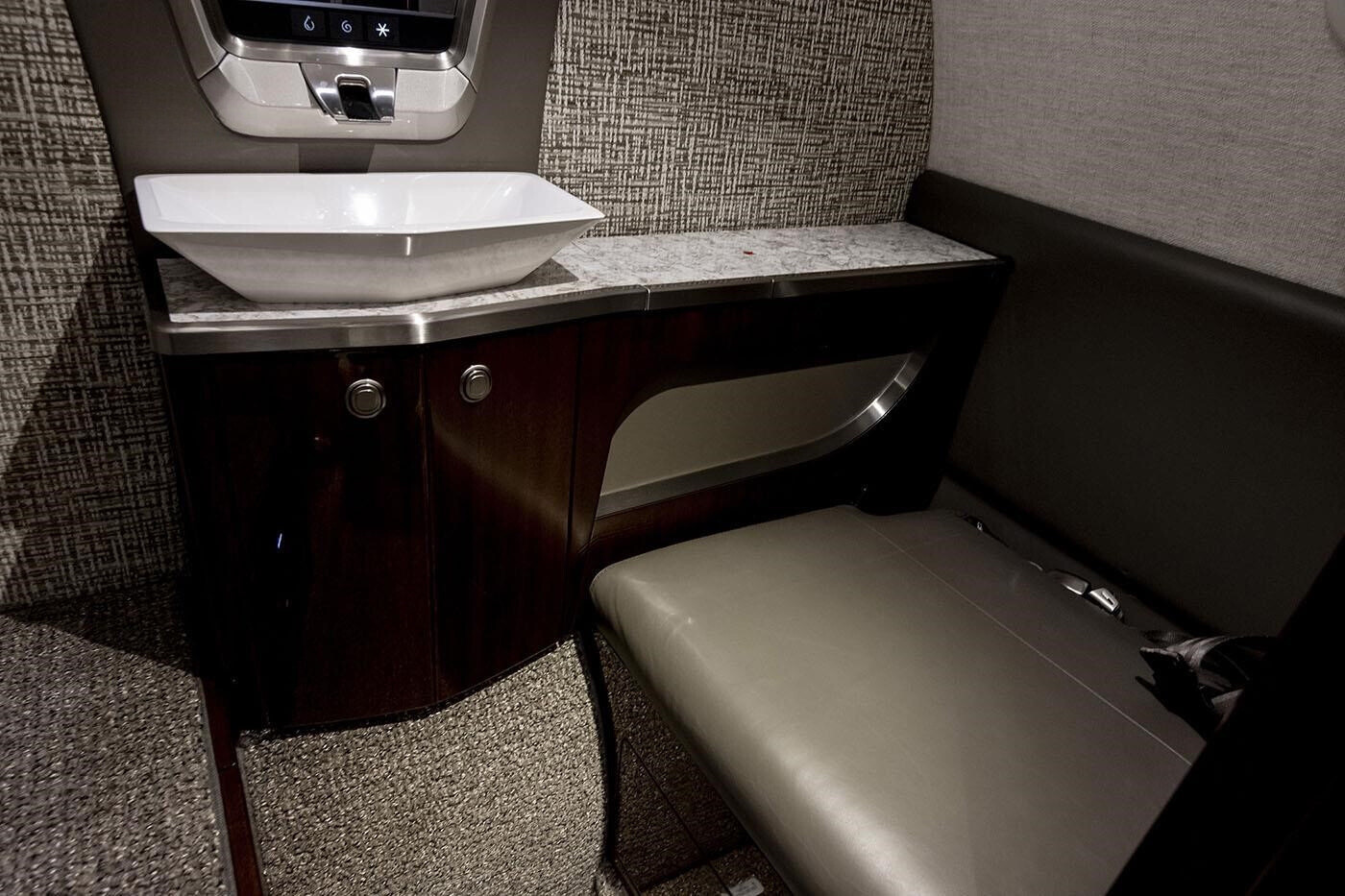 Left-hand aft belted flushing toilet inside the 2023 Citation CJ4 Gen2 private jet.