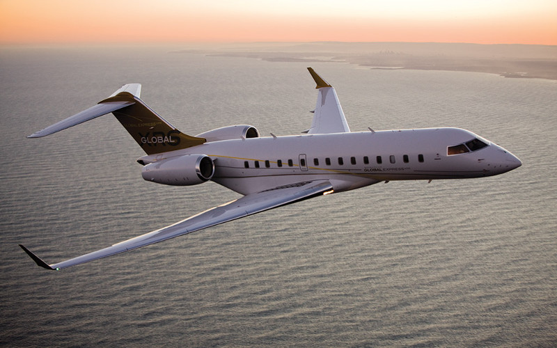 “Bombardier Global Express XRS ultra long-range large-cabin private jet in flight over the ocean at sunset, high-performance executive aircraft designed for intercontinental business aviation and global corporate travel.