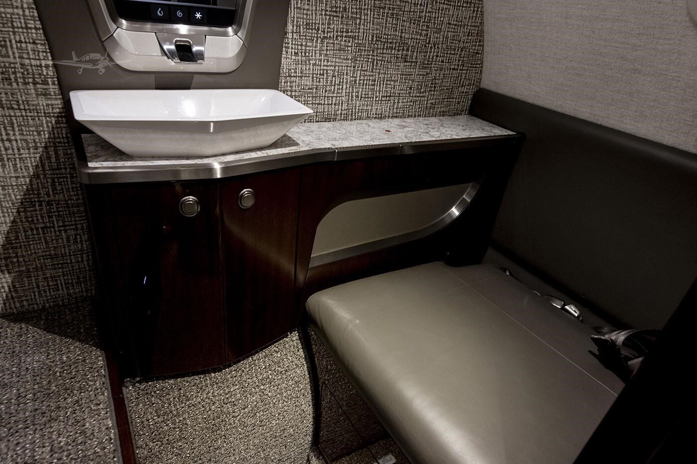 Left-hand aft belted flushing toilet inside the 2023 Citation CJ4 Gen2 private jet.