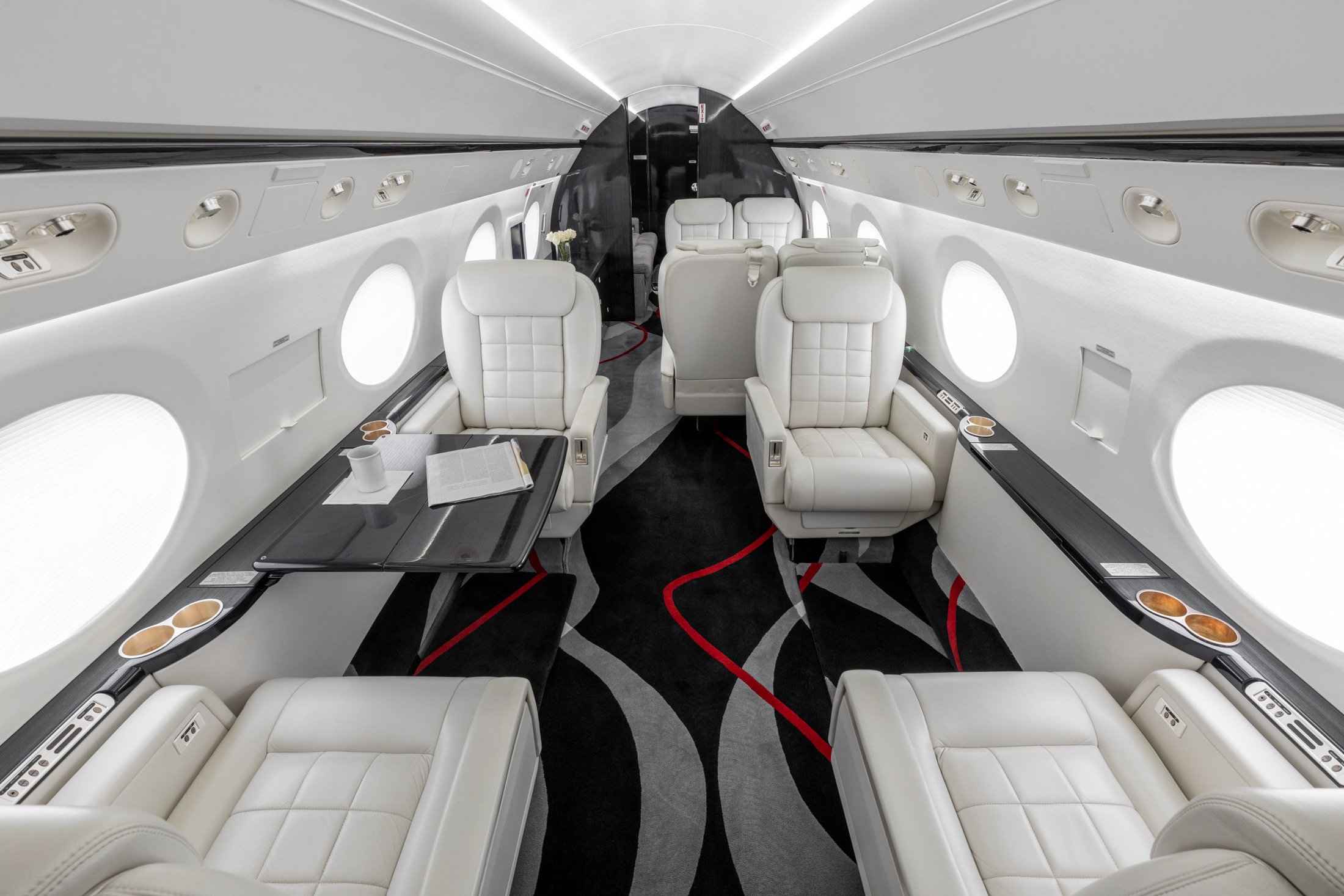 Interior view of the first four passenger seats in the 2005 Gulfstream G550, showcasing luxurious leather upholstery and spacious seating arrangements.