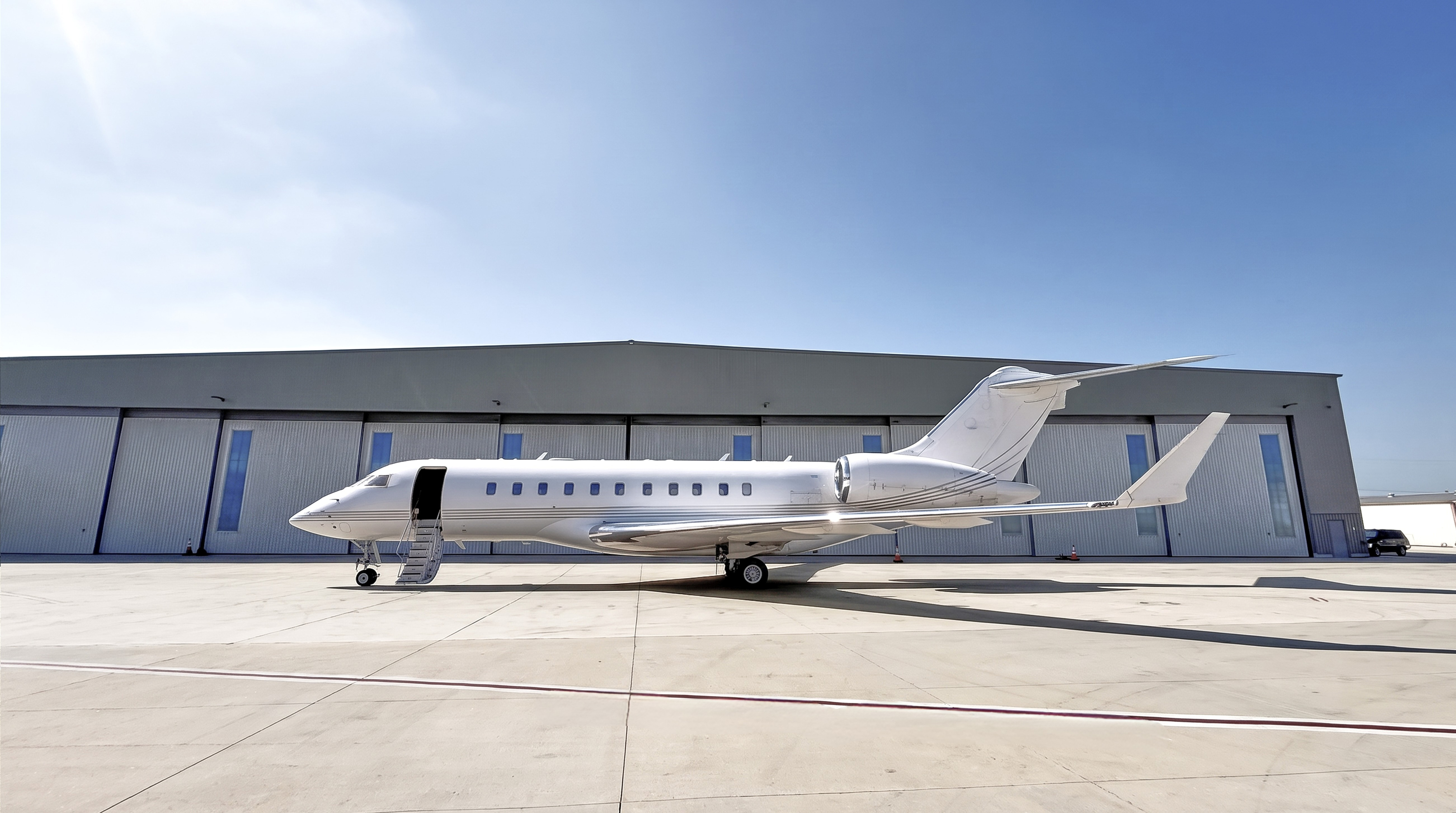 2007 Bombardier Global 5000 private jet parked on the ramp, exterior side view