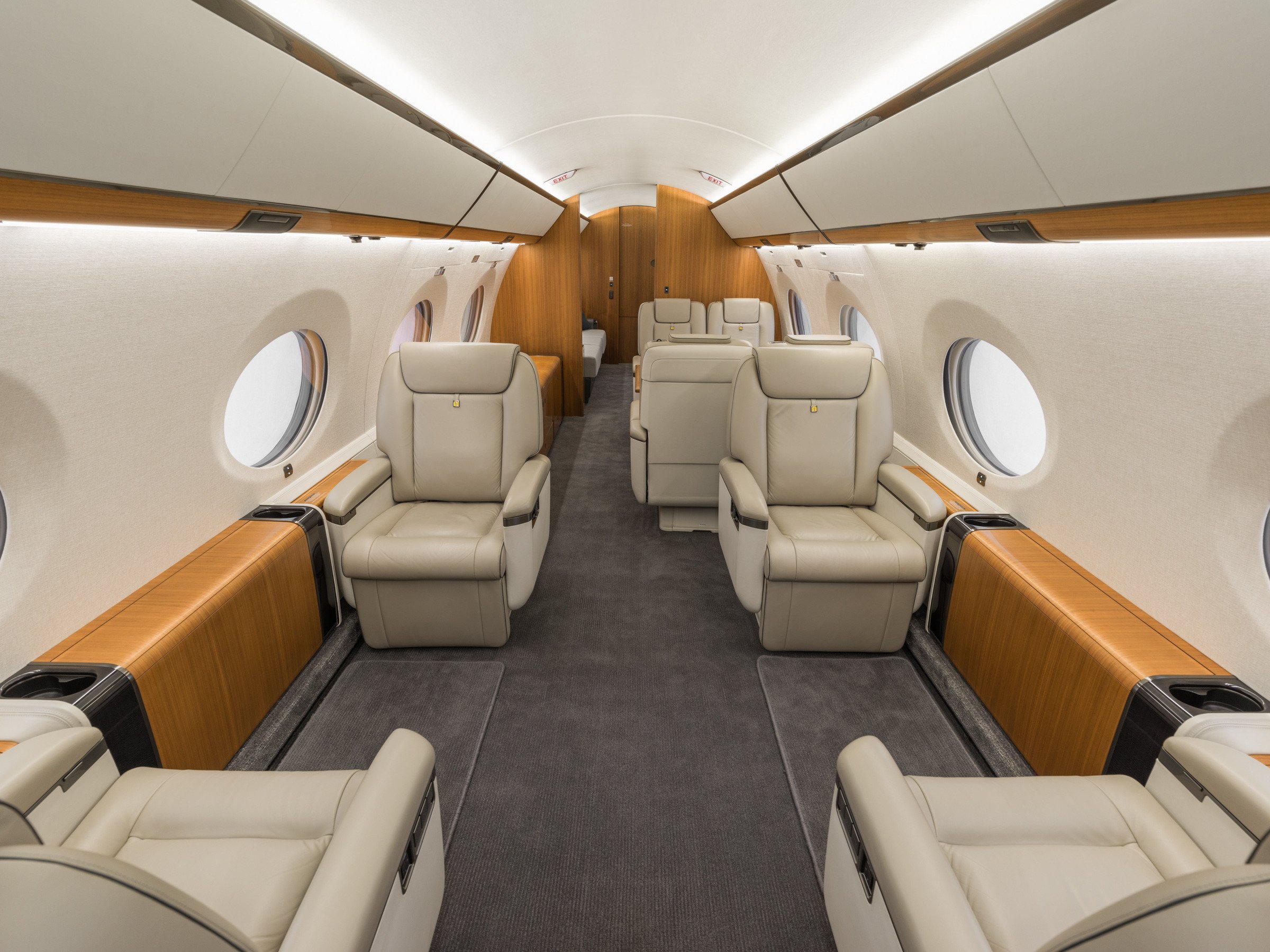 Luxurious forward cabin of the Gulfstream 650ER with four plush leather seats, offering unparalleled comfort and sophistication in private air travel.