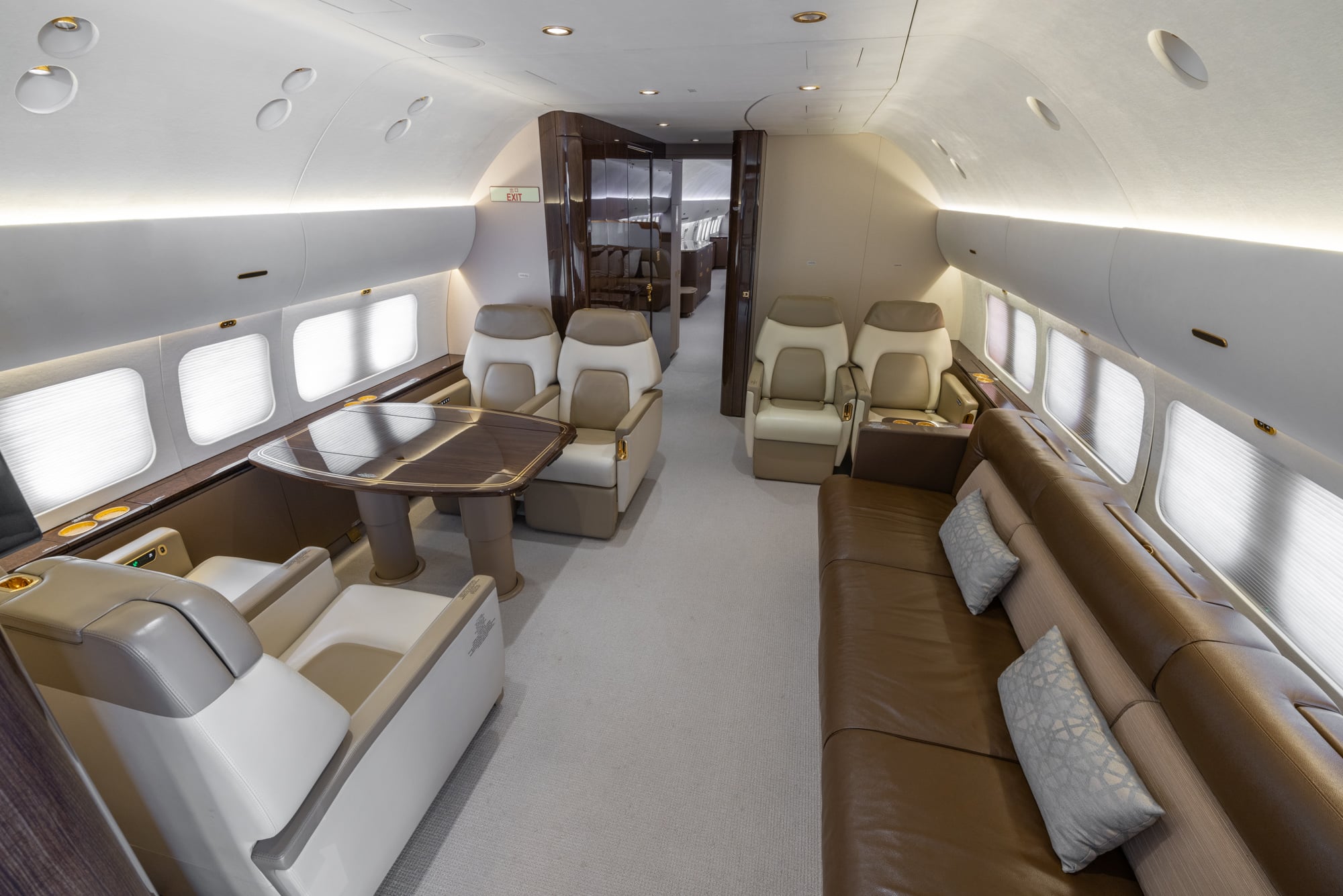 Interior of a 2018 Boeing Business Jet 2 (BBJ2) featuring a spacious VIP cabin with premium leather seating, a conference table, elegant wood finishes, and luxury accommodations for long-range private travel.